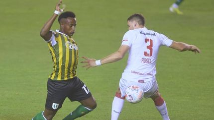 Cuero y Rogel se disputan la posesión de la pelota.