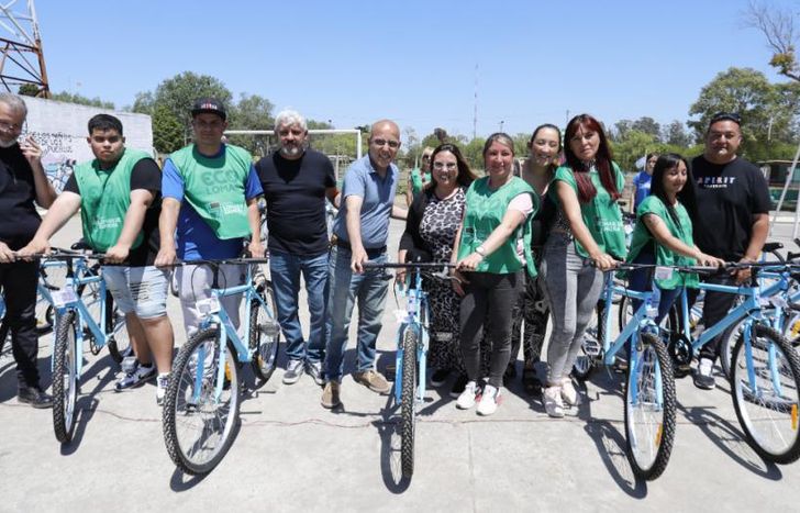 Las autoridades junto a los trabajadores beneficiados con las bicicletas.